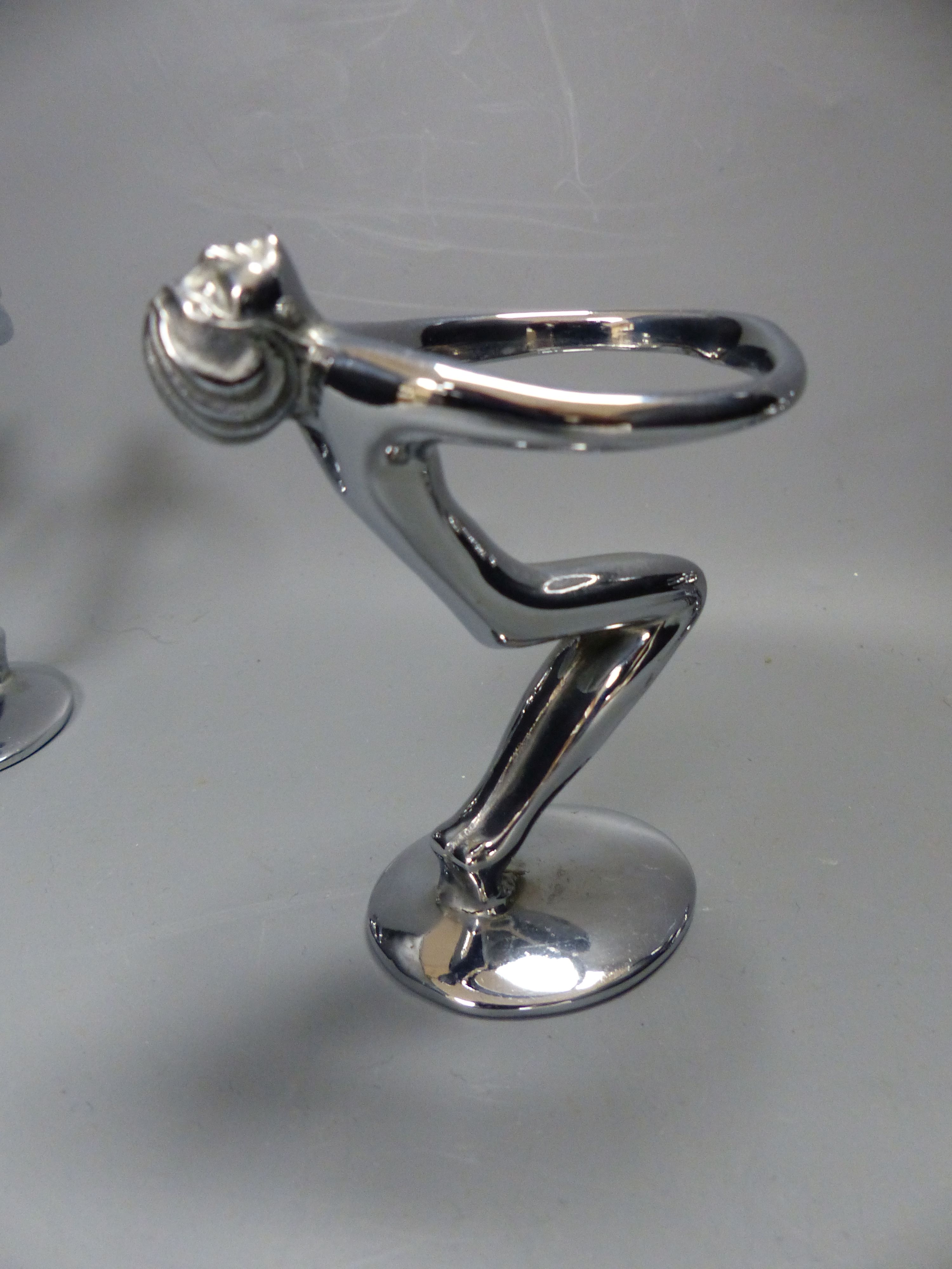 A post war chrome set of six figural egg holders, height 9cm